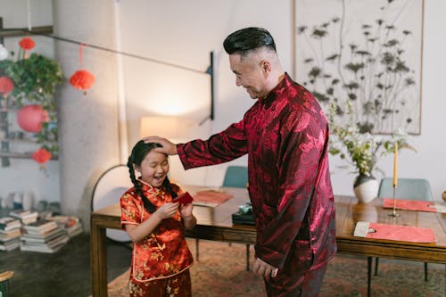 An Elderly Man Giving an Angpao to his Granddaughter