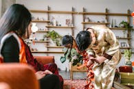 A Girl and a Boy Holding Ang Paos Bowing to Parents