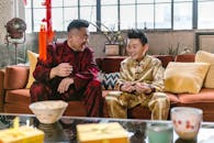 A Father and Son Sitting on Couch Smiling