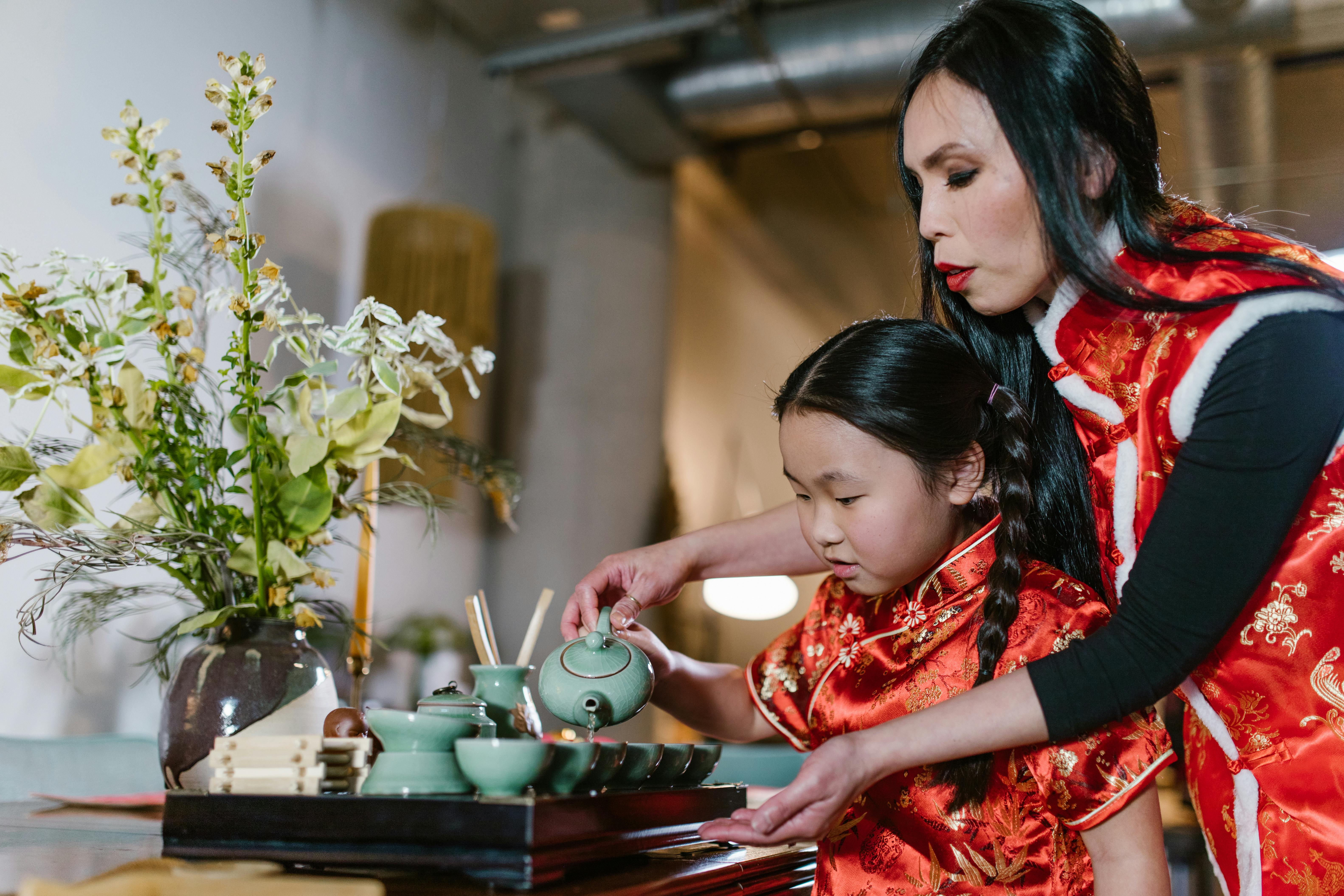 a mother pouring tea with her daughter