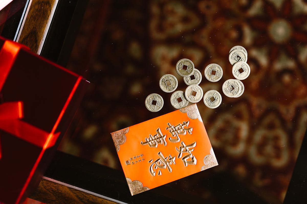 Doctor writing notes while looking at health data and charts on a desk