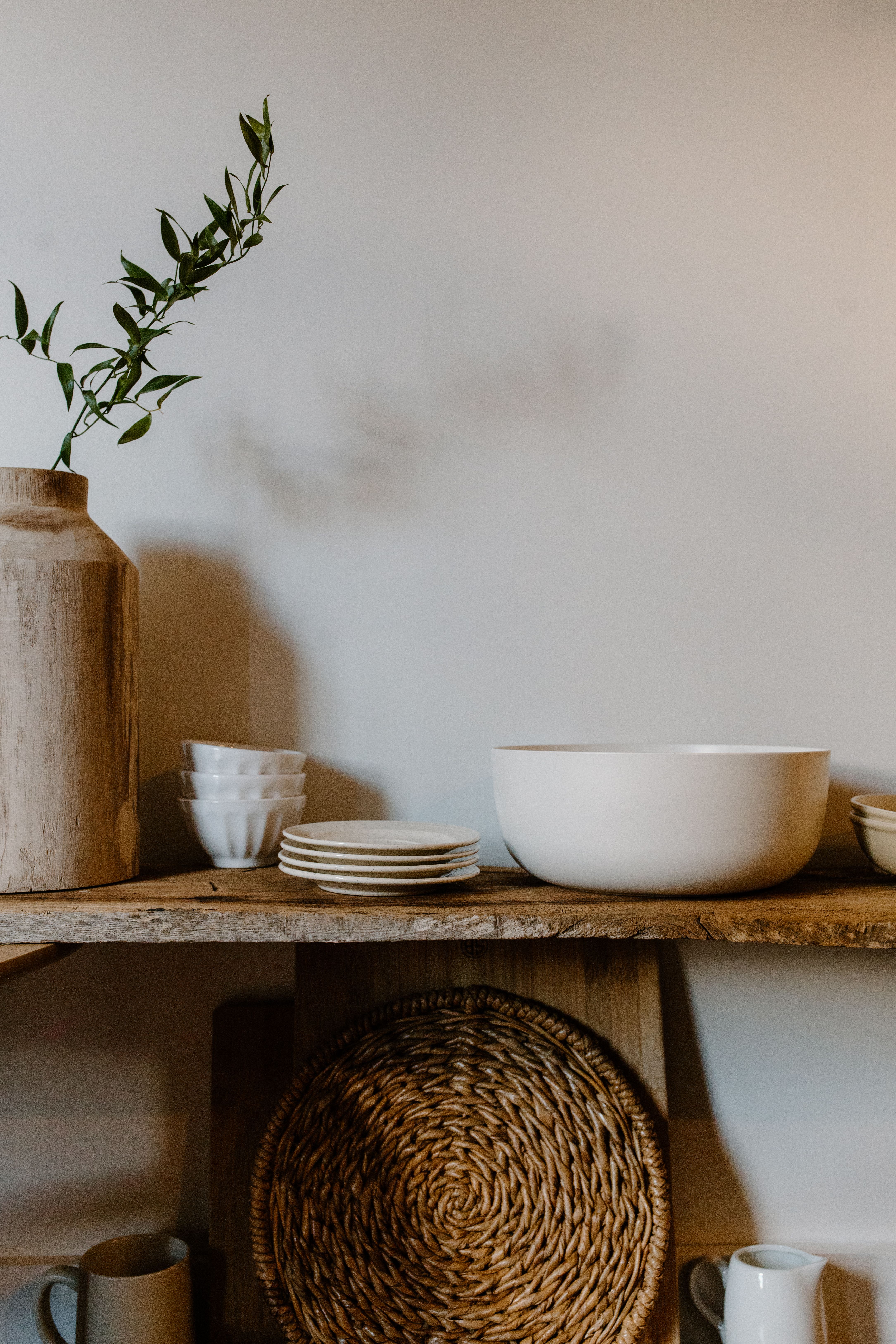 bowls and saucers on a wooden shelf