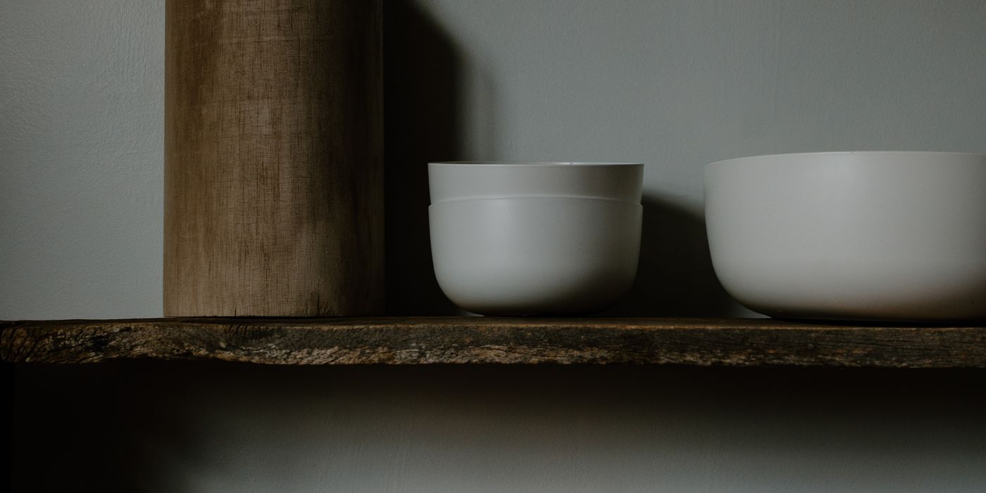 Minimalist ceramics and vases on wooden shelves neutral tones
