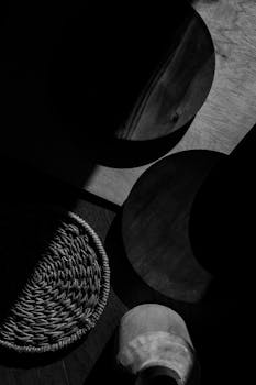 Black and white minimalistic setup with Japandi style décor featuring wood and woven textures.