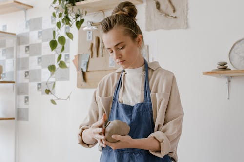 Free A Woman Holding a Ball of Clay Stock Photo