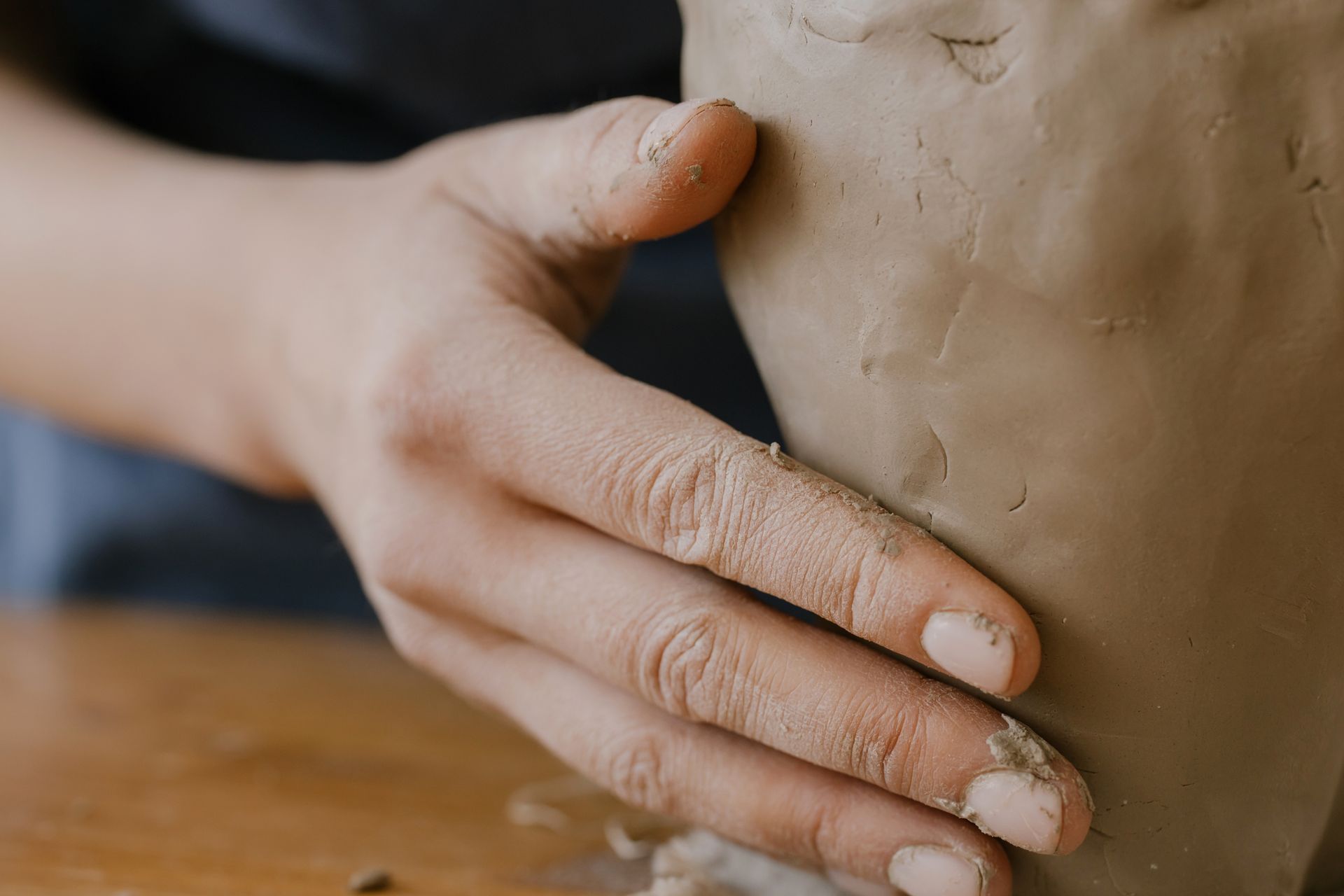 A Person Touching the Clay in Close-up Photography
