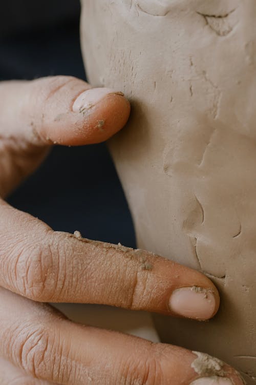 Close-up o f a Person's Hand Molding a Clay Pot