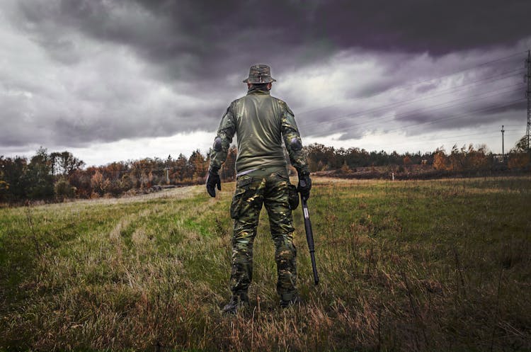 Man In Camouflage Suit Holding Shotgun