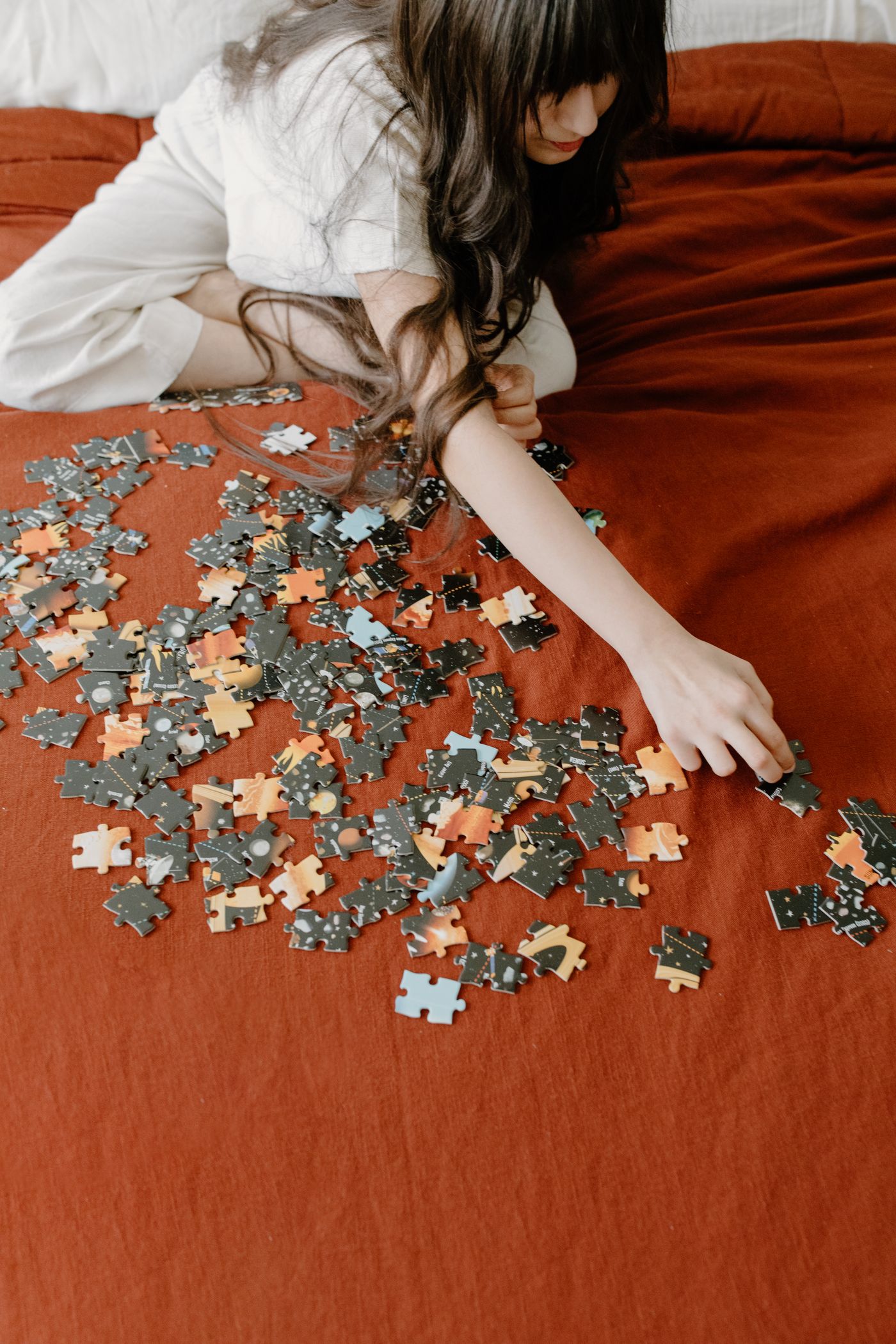 Child concentrating on assembling a colorful puzzle during quiet indoor play