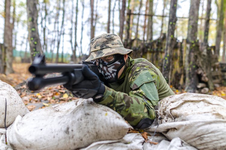 Soldier Holding A Rifle At Daytime