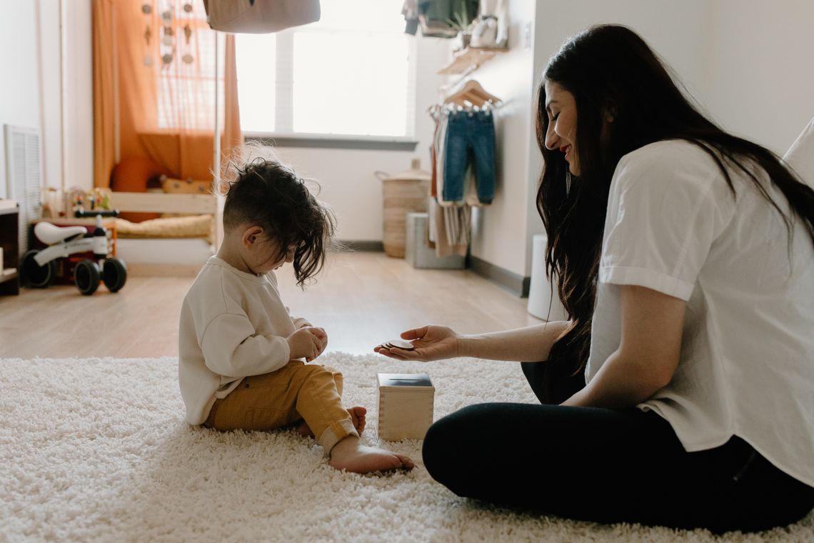 Mother and young child sharing a focused educational play activity