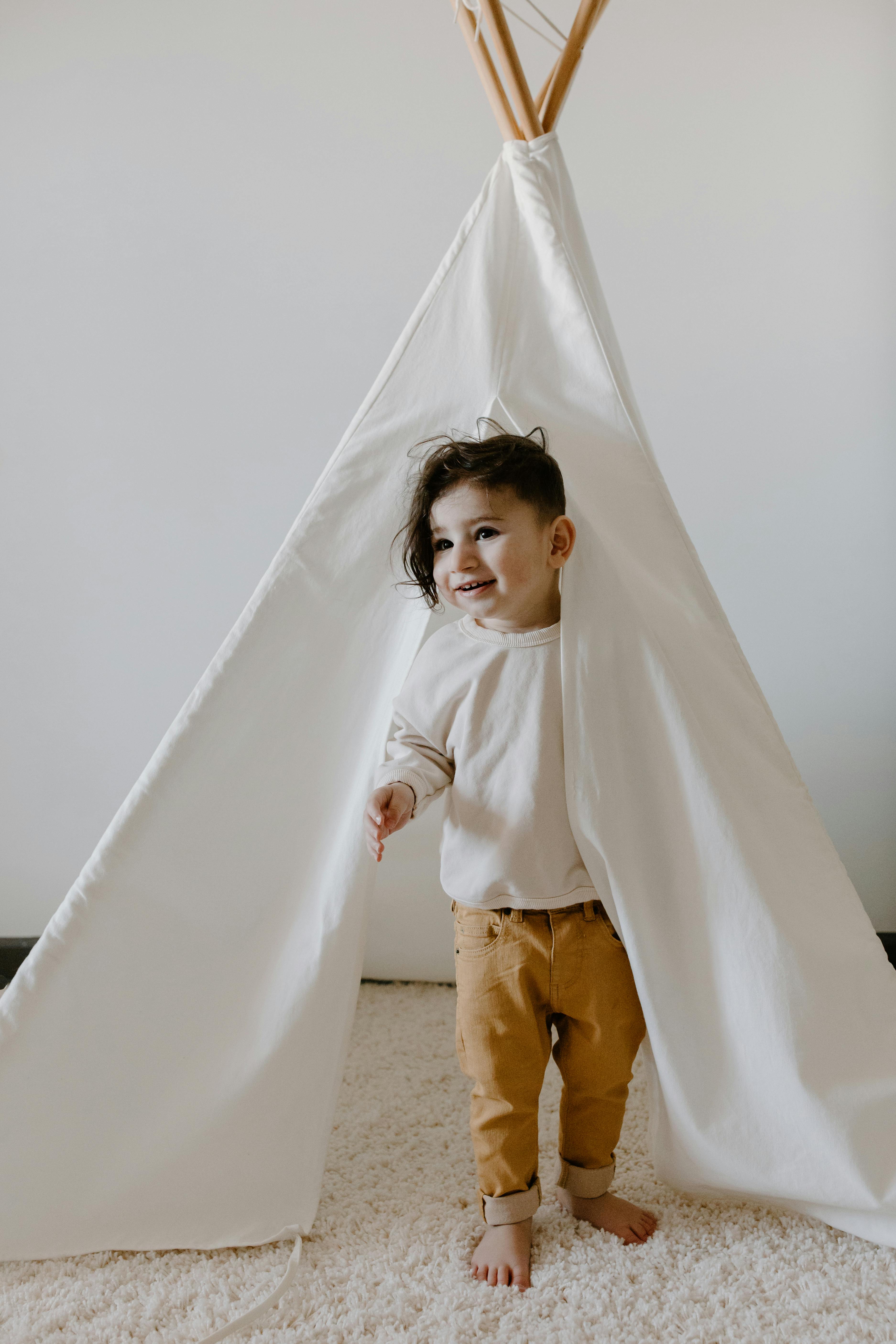 a child standing on the tent opening