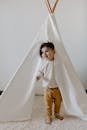 A Child Standing on the Tent Opening