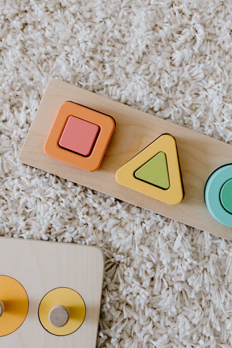 Colorful Wooden Educational Toy On A Carpet