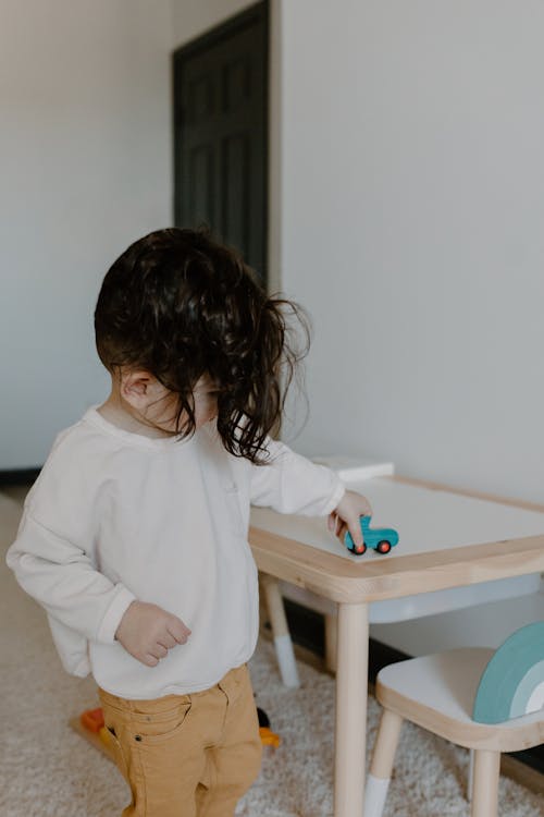 Young Boy Playing Alone with His Toy