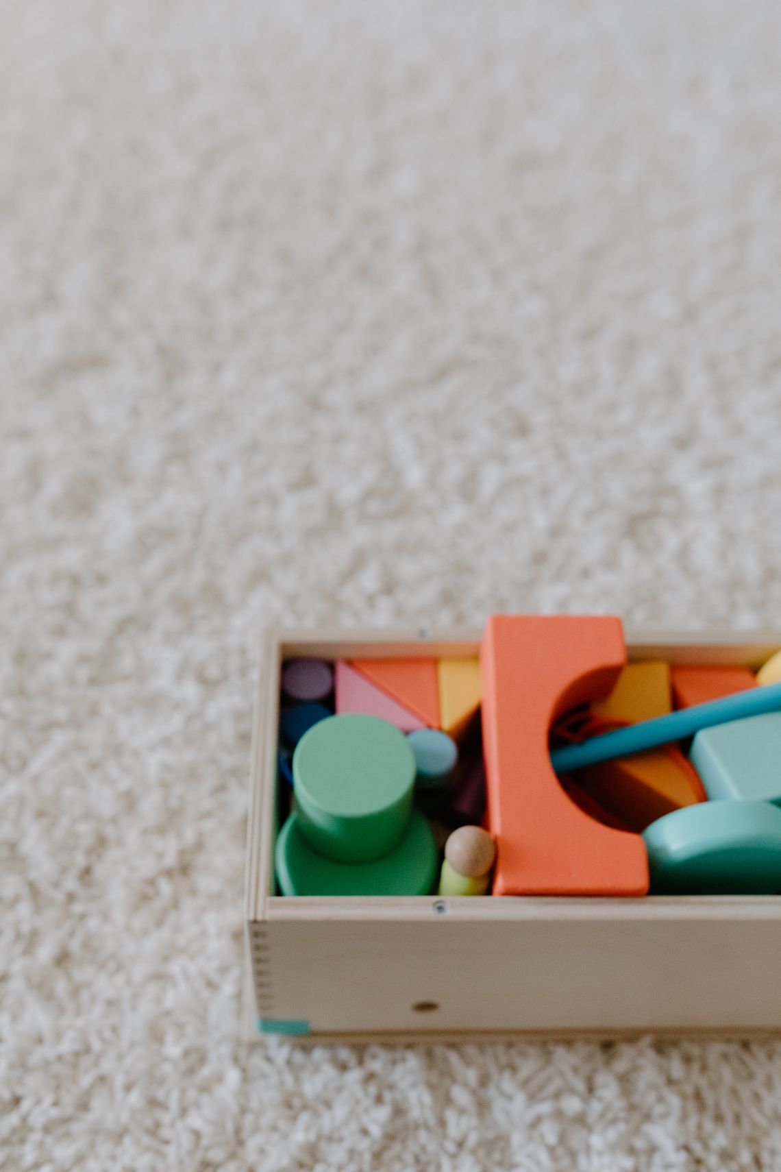 Box filled with colorful educational wooden toys