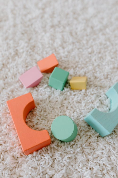 Colorful Wooden Blocks on White Carpet