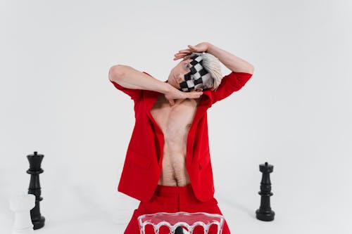 A Shirtless Man in a Red Suit with Face Makeup