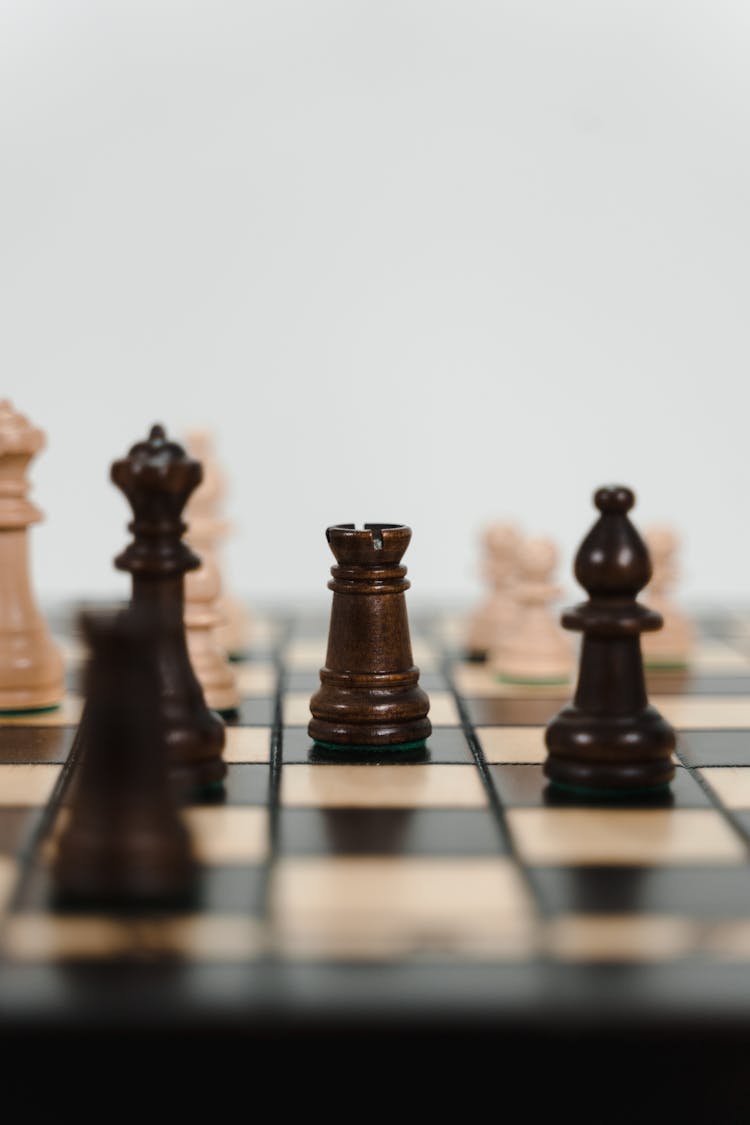 Wooden Chess Pieces On A Chessboard