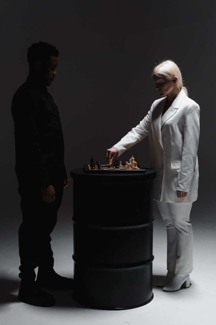 A Man And A Woman Playing Chess