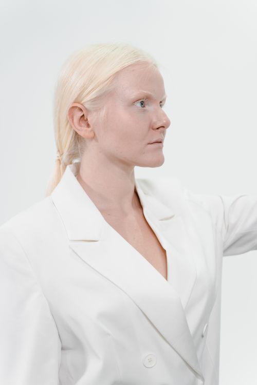 Free Side profile of a fashionable caucasian woman in a white suit on a white background. Stock Photo