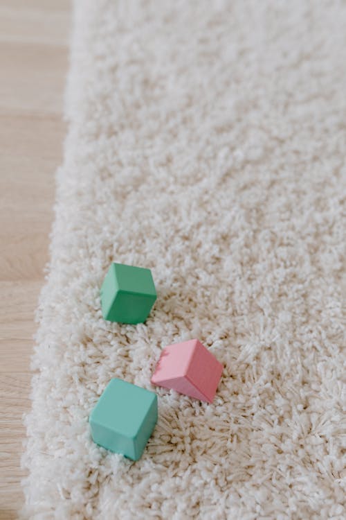 Free Colorful Wooden Cube Blocks on a White Rug Stock Photo