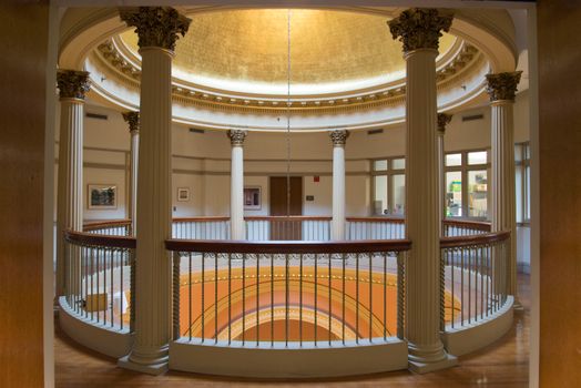 Classic architectural interior featuring a dome with decorative pillars and railings.