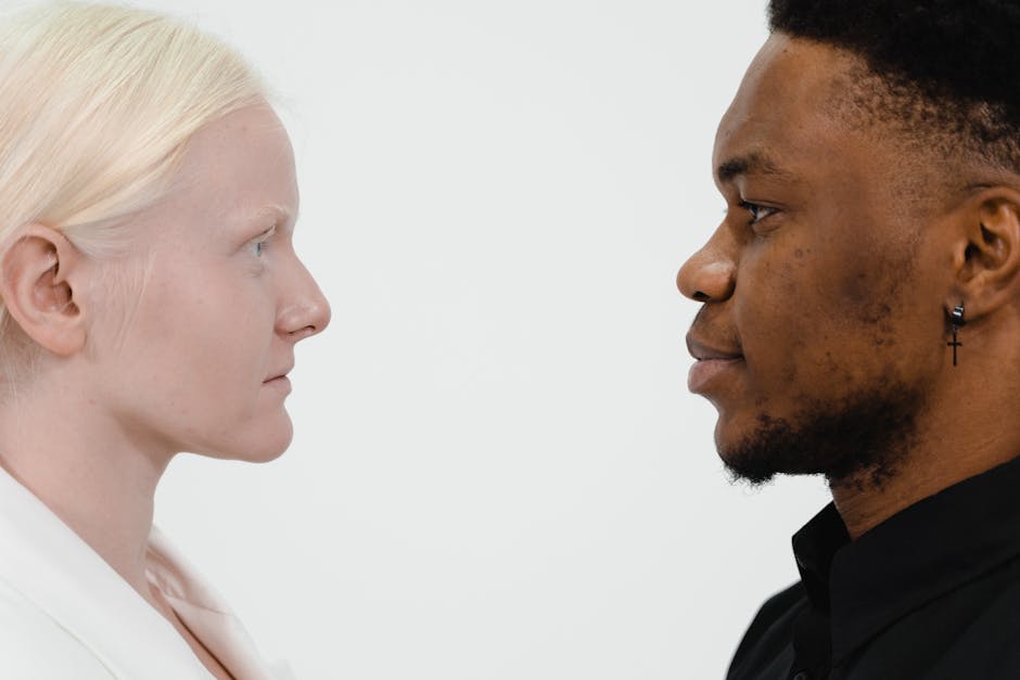 Profile view of a Caucasian woman and an African American man facing each other.