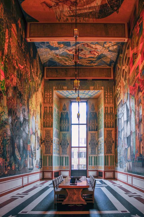 Free A richly decorated room with murals and large windows allowing natural light into the space. Stock Photo