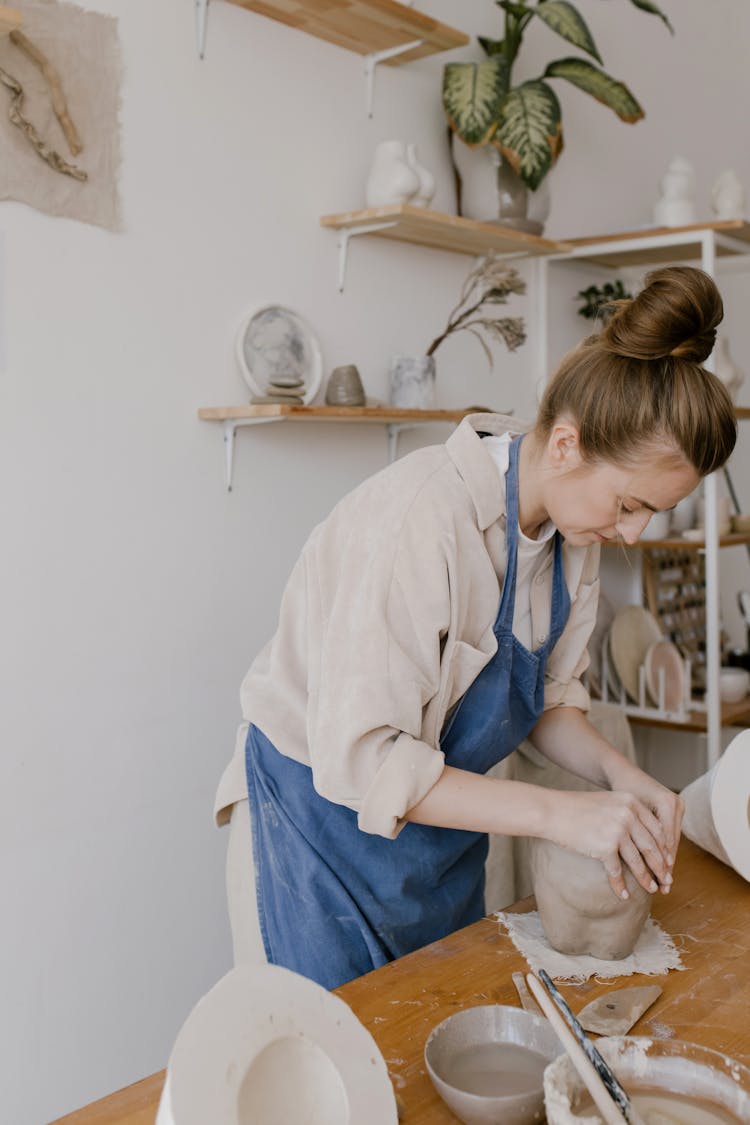 An Artisan Molding A Clay