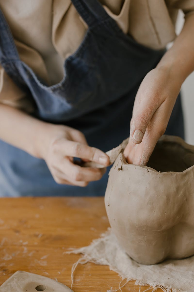 Potter working at wheel in Omaha ceramics studio