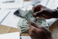 Person Holding Fan of Us Dollar Bill