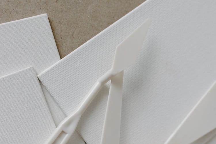 Plastics Palette Knives On White Canvas