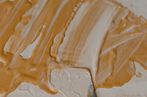 Free Artistic close-up of acrylic paint in orange hues, showcasing texture and knife painting technique. Stock Photo