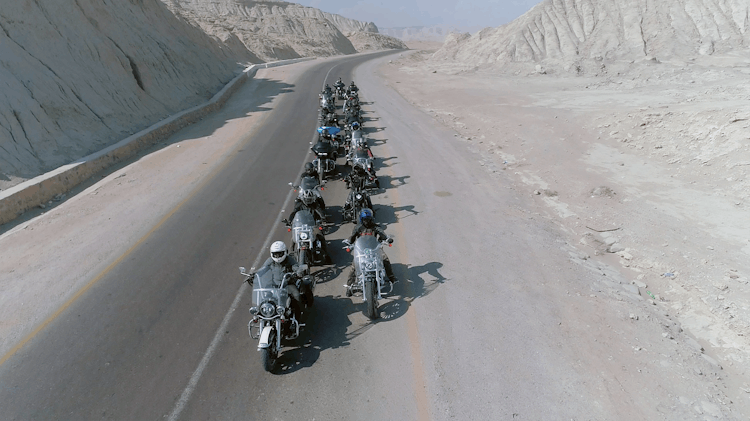 Motorcycle Group Riding Through Desert Area