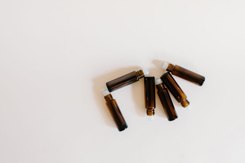 Row of amber glass oil bottles on a counter