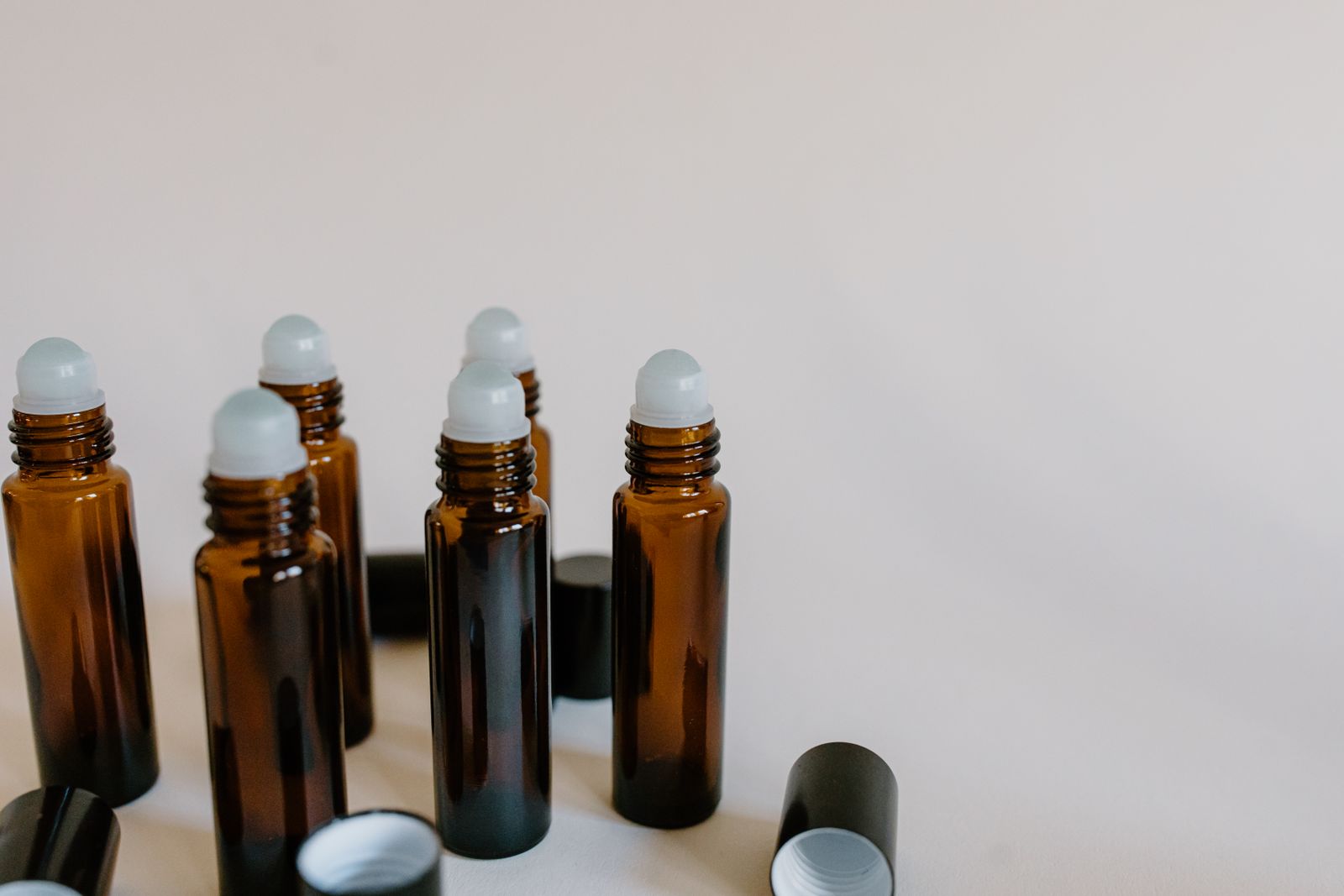 Amber roller bottles lined up on a table