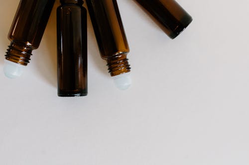 Brown Roller Bottles in Close Up Photography