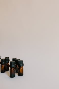Close-up of brown essential oil bottles on a white background with copy space.