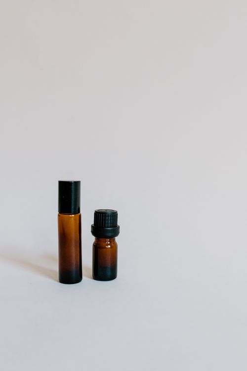 Free Two brown glass bottles for essential oils on a clean white background, perfect for product showcase. Stock Photo