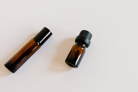 Close-up of brown essential oil bottles on a white background, ideal for aromatherapy product mockups.