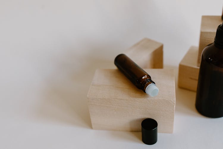 Brown Roller Bottle On Wooden Block