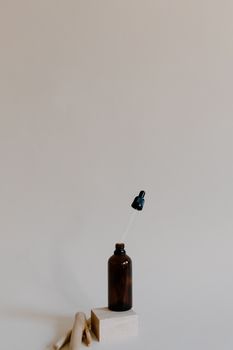 Elegant brown dropper bottle with copy space in a minimalist setting, ideal for wellness and aromatherapy concepts.