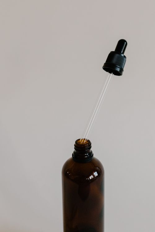 Free Close-up of a brown bottle with a dropper, perfect for aromatherapy and essential oils. Stock Photo