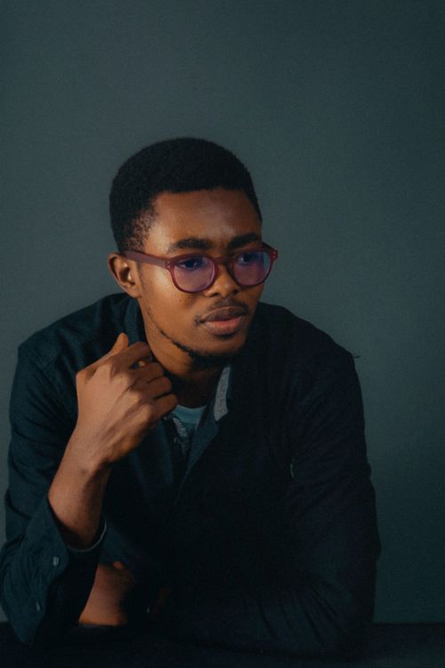 Free Close-up portrait of an adult man wearing eyeglasses and a dark shirt, gazing thoughtfully. Stock Photo