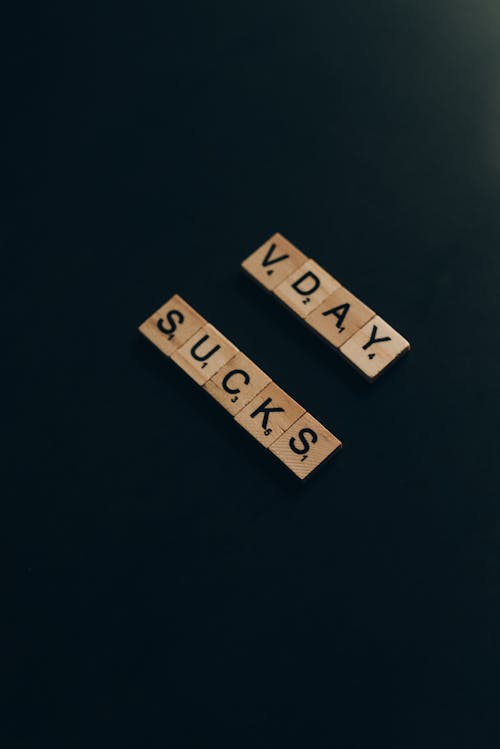 Free Wooden Scrabble Tiles on Black Background Stock Photo