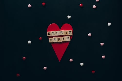 Wooden Scrabble Tiles on Red Paper Heart