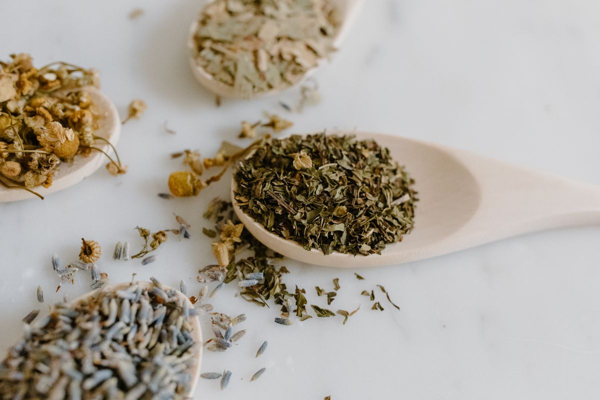 Herbal adaptogenic medicine on a wooden spoon, representing ashwagandha and rhodiola as natural stress remedies