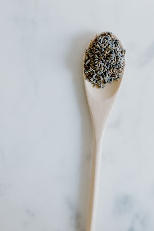 Free Close-up of a wooden spoon holding dried lavender buds on a marble surface, perfect for natural remedy themes. Stock Photo