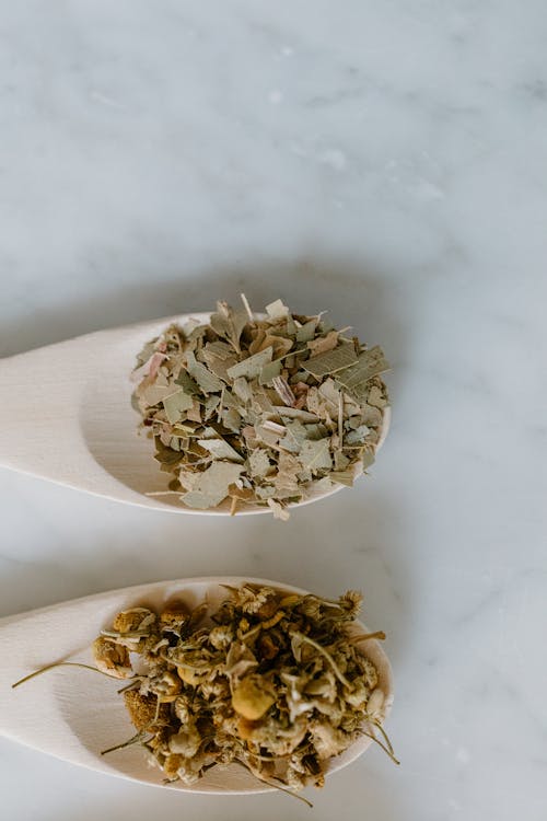 Close-Up Shot of Herbal Medicines on Wooden Spoons